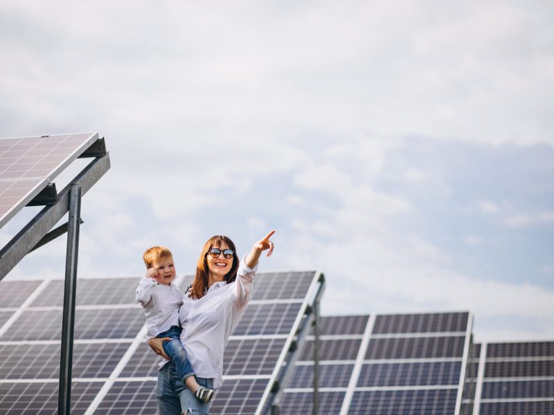 mother-with-her-little-son-by-solar-panels